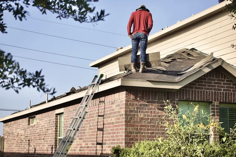 Professional roofer working on a residential roof in Merrifield